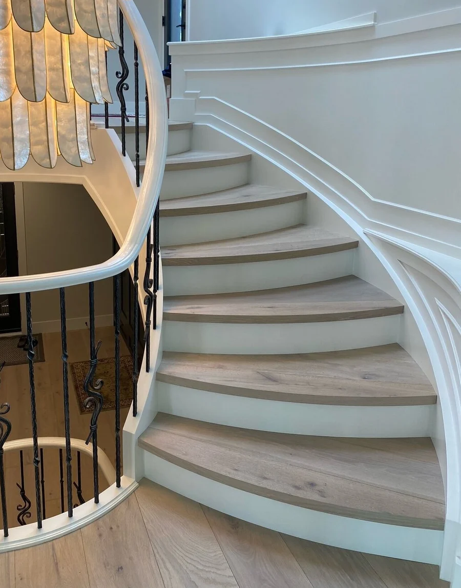 Custom flush stair nosing on a curved staircase in a Calgary home